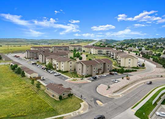 A large, well-maintained housing development with a clear sky above.