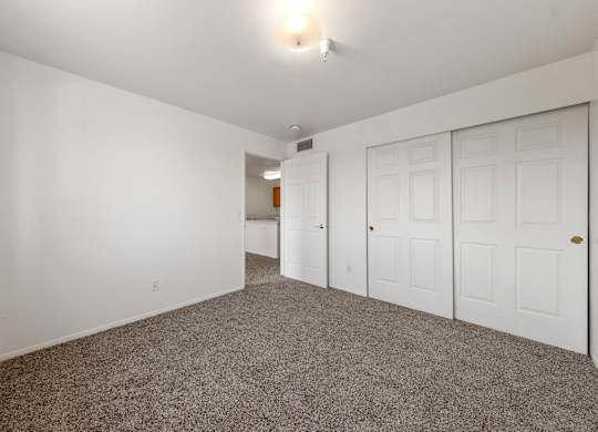 A room with white walls and a carpeted floor.