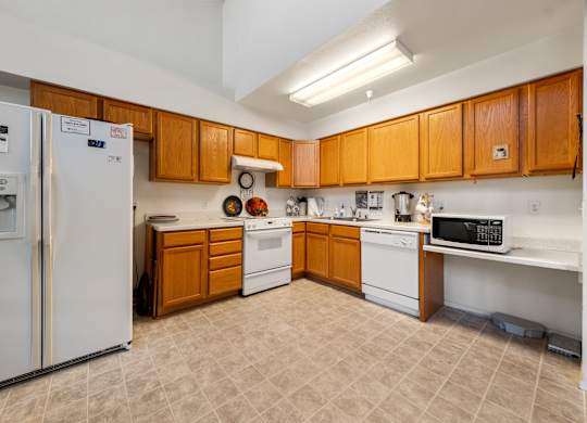 A kitchen with wooden cabinets and a white refrigerator.