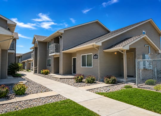 A row of houses with a clear blue sky above them.