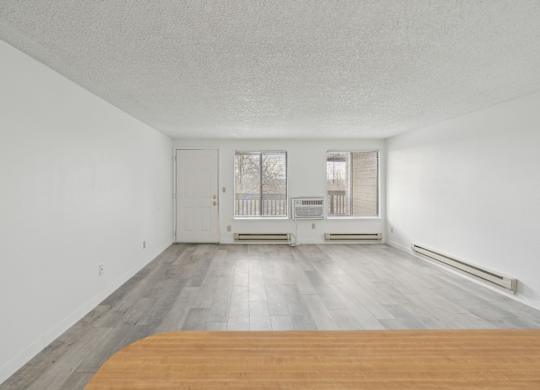 A room with a wooden floor and white walls.