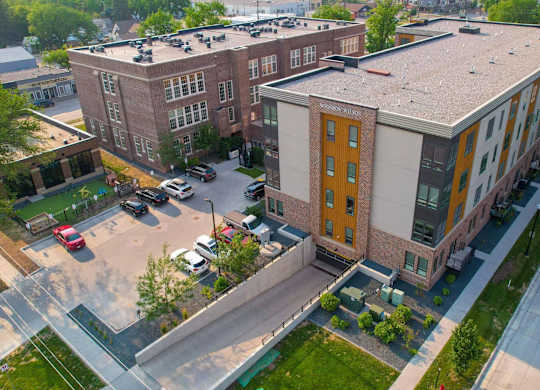 A parking lot in front of a building with a yellow door.