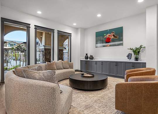 A living room with a brown chair and a grey couch.