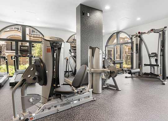 A gym with a variety of equipment including a leg press machine.