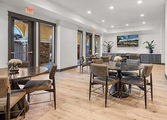A dining room with a table and chairs.