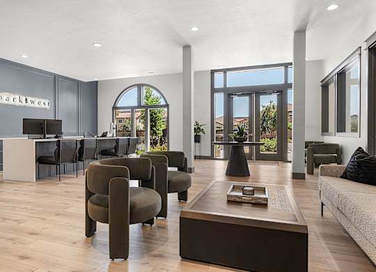A living room with a sofa, armchairs and a coffee table.