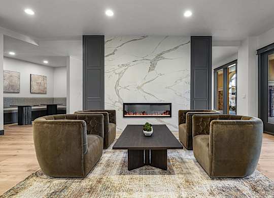 A living room with a fireplace and a rug.