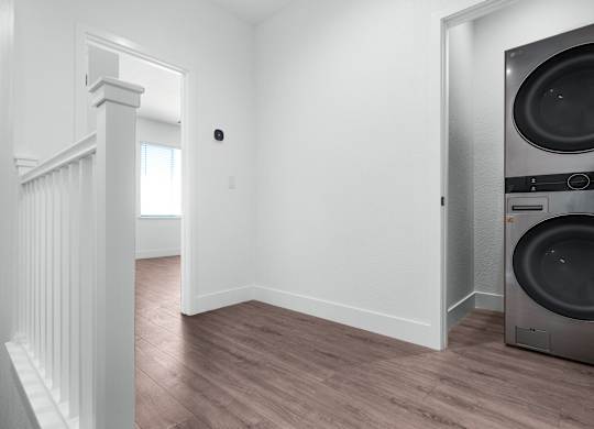 an empty laundry room with a washer and dryer