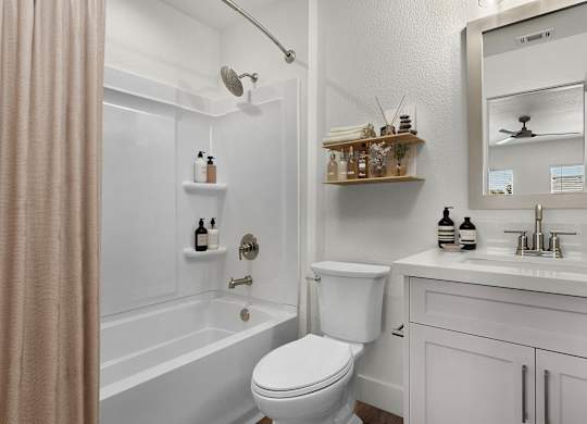 a bathroom with a toilet and a tub and a sink