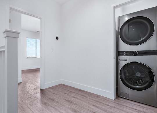 an empty laundry room with a washer and dryer
