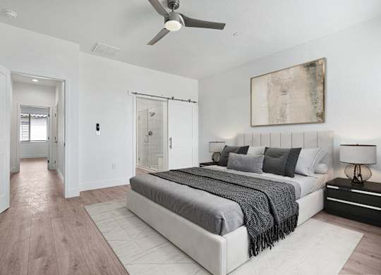 a bedroom with a bed and a ceiling fan