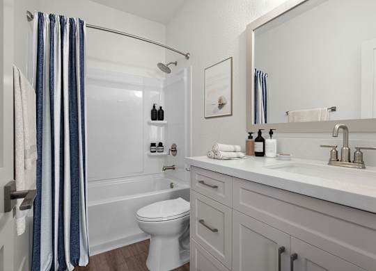 a white bathroom with a shower and a sink and a toilet