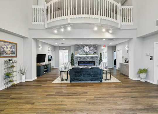 A spacious living room with a fireplace and a balcony.