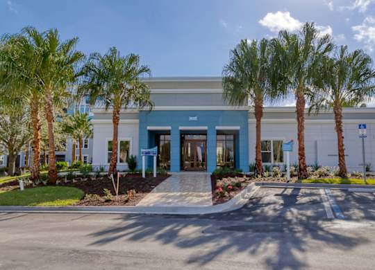 Modern clubhouse entrance with palm trees at Ciel Luxury Apartments, Jacksonville, FL