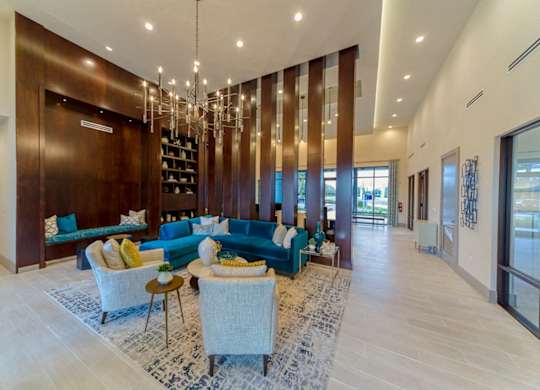Contemporary living room with blue sectional sofa at Ciel Luxury Apartments, Jacksonville