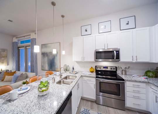 Modern kitchen with white cabinets and island at Ciel Luxury Apartments, Jacksonville, 32246