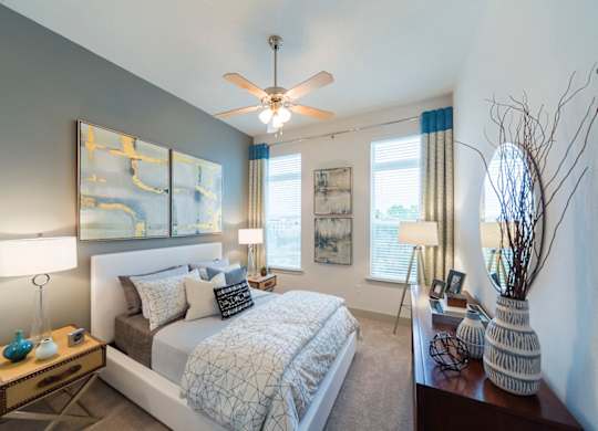 Modern bedroom with gray accent wall at Ciel Luxury Apartments, Florida