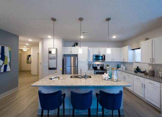 Kitchen island with blue bar stools at Ciel Luxury Apartments, Jacksonville, FL