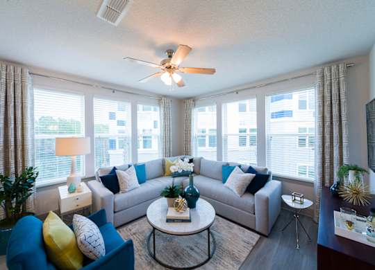 Bright living room with corner sectional sofa at Ciel Luxury Apartments, Jacksonville, 32246