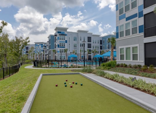Bocce ball court with colorful balls on green surface at Ciel Luxury Apartments, Florida