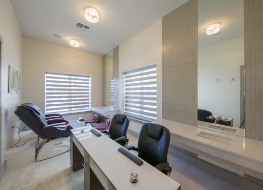 Hair salon styling station with modern chairs and mirrors at Ciel Luxury Apartments, Jacksonville