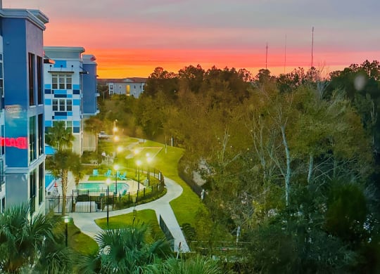 Sunset view over winding walkway and tropical landscaping at Ciel Luxury Apartments, Jacksonville, Florida