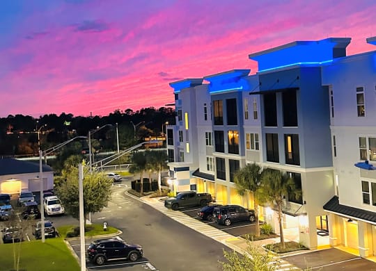 Modern apartment buildings at sunset with parking at Ciel Luxury Apartments, Jacksonville