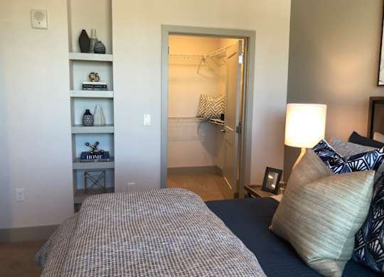 Bedroom with walk-in closet and builtin shelving at Ciel Luxury Apartments, Jacksonville, FL 32246