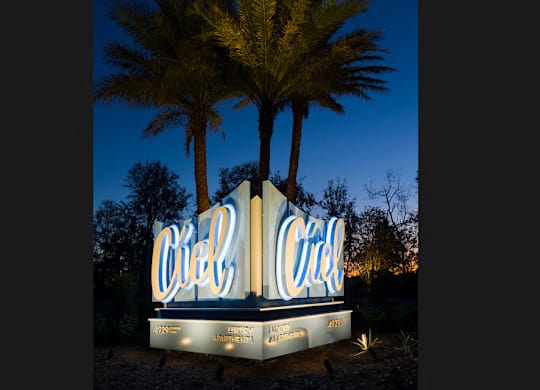 Illuminated property entrance sign with palm trees at Ciel Luxury Apartments, Jacksonville