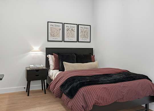 Bedroom with Cozy Bed and Nightstand at Richmond Square, Ontario