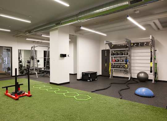 A gym with a green floor and white walls.