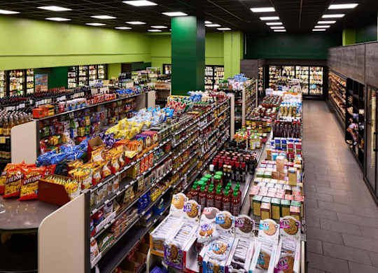 A supermarket aisle with a variety of snacks and drinks.