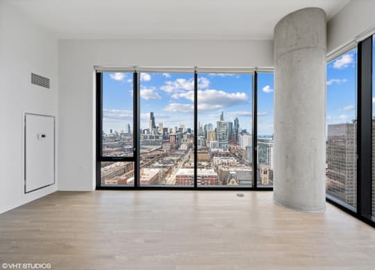 A large room with a view of the cityscape outside the window.