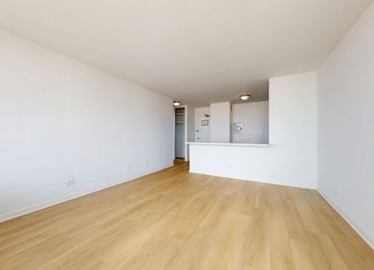 A room with wooden floors and white walls.