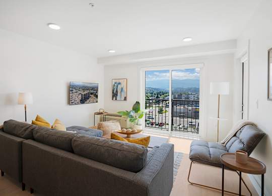 A living room with a grey couch and a chair.
