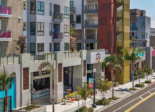 Contemporary mixed use building with street level retail at AMP 30 Apartments, California
