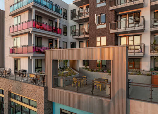 Rooftop terrace with dining area and greenery at AMP 30 Apartments, San Diego, CA 92116