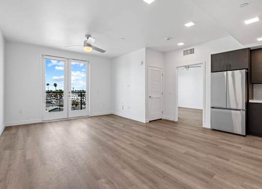 Open concept living room with balcony access at AMP 30 Apartments, San Diego, 92116