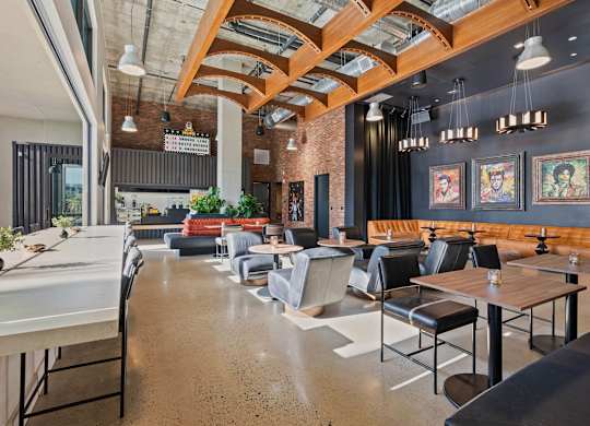 Clubhouse lounge with curved wood beam ceiling at AMP 30 Apartments, San Diego, CA