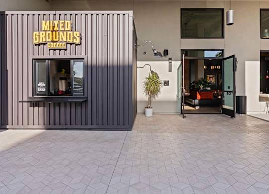 Coffee kiosk and community courtyard entrance at AMP 30 Apartments, California