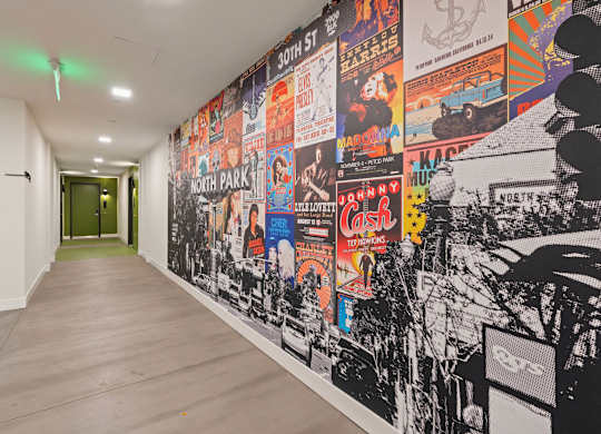 Hallway with vintage music poster collage wall at AMP 30 Apartments, San Diego, 92116