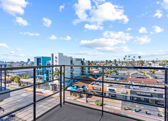 Balcony view overlooking urban neighborhood and palm trees at AMP 30 Apartments, California