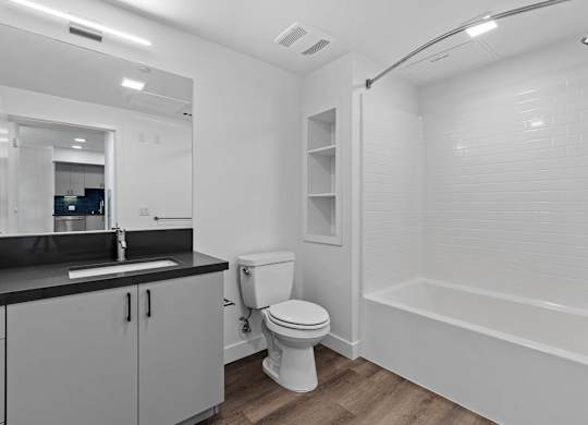 Bathroom with black countertop and white subway tile at AMP 30 Apartments, California, 92116