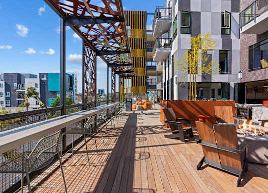 Rooftop terrace with fire pit and wooden deck seating at AMP 30 Apartments, San Diego, CA 92116