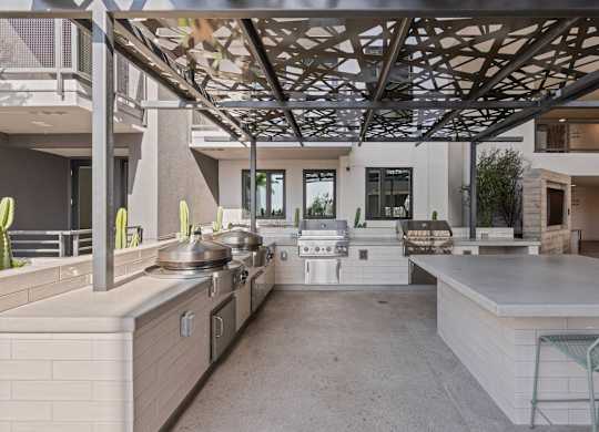 Outdoor grilling station with decorative overhead canopy at AMP 30 Apartments, San Diego, California