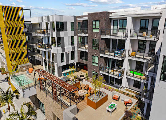 Central courtyard with pergola and communal amenities at AMP 30 Apartments, San Diego, CA