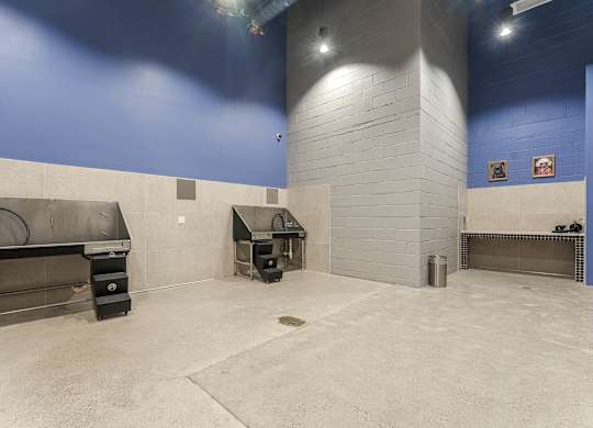 Indoor grilling area with commercial smokers and blue walls at AMP 30 Apartments, California, 92116