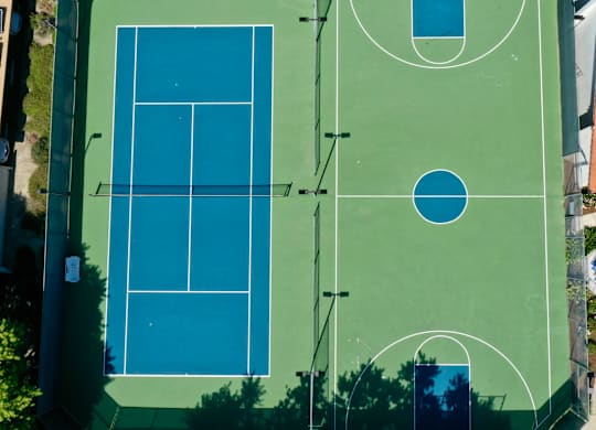 A tennis court is shown from an aerial view.