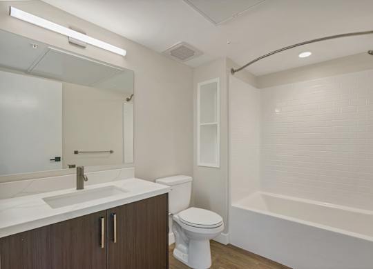 A white toilet sits next to a sink in a bathroom.