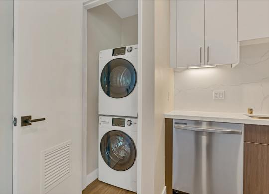 A white front-loading washing machine is in a laundry room.